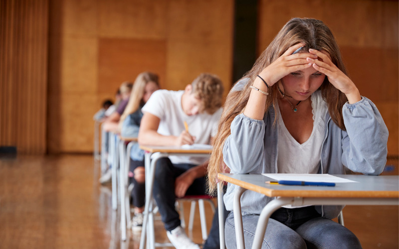 Anxious woman looking down at test paper