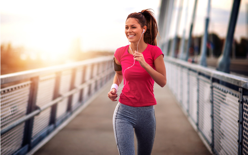 Happy fit woman running outdoors